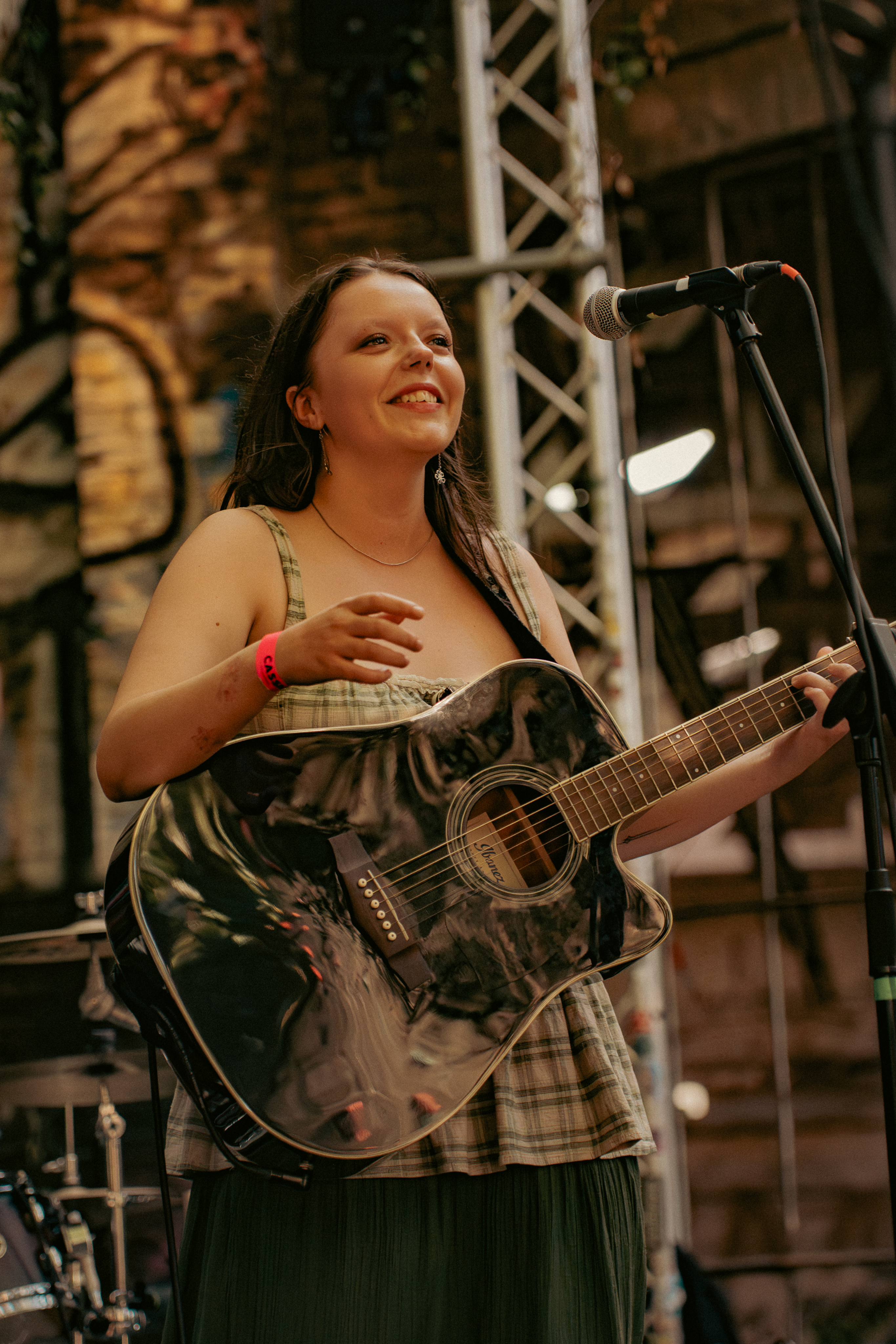 person with guitar on stage