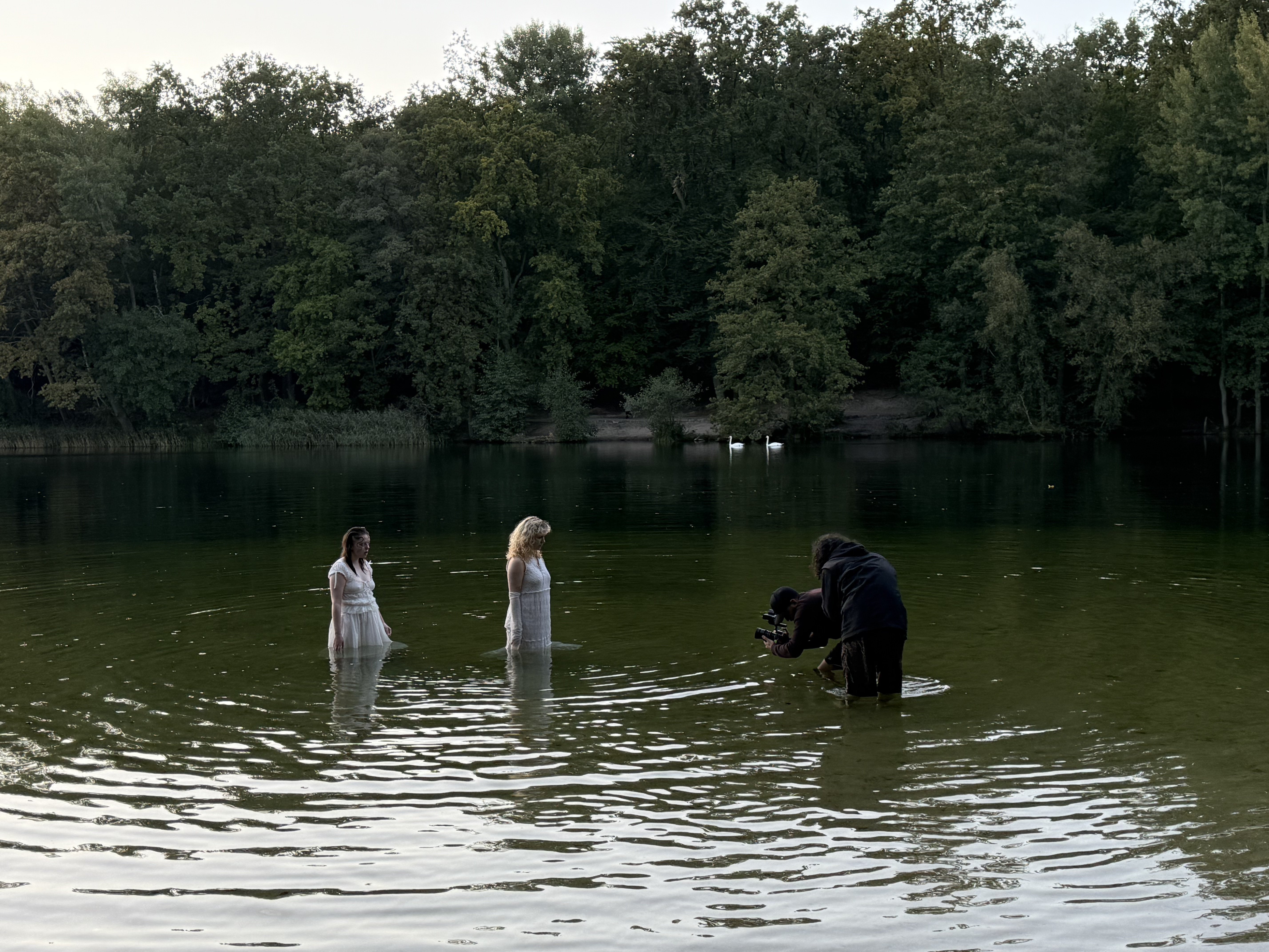 camera person filming two people in a lake